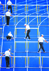 Volunteers replace the hurdles in the track after a heat in the mens 110 metres hurdles during the World Athletics Championships at the Olympic stadium in Berlin on Wednesday. 