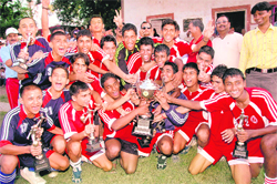 The DAV Inter-College team poses with the U-19 District Football Trophy in Dehradun on Thursday.
