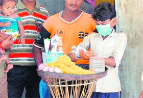 SWINE FLU SCARE: A vendor wears a protective mask in front of the Civil Hospital in Gurgaon