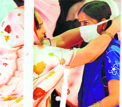 People wear protective masks as they wait to undergo H1N1 virus test at Ram Manohar Lohia Hospital in New Delhi on Thursday. 