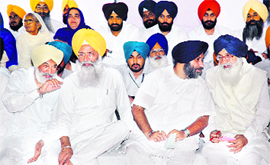 (From right) Chief Minister Parkash Singh Badal and son Sukhbir Badal share a point at a function at Longowal village on Thursday.