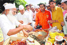 Devotees make purchases ahead of Ramzan at a stall put up near Jama Masjid at Sector 20 in Chandigarh on Friday.