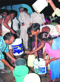 Residents fill water from a tanker at Budhanpur village in Panchkula on Friday.