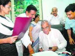 Haryana Chief Minister Bhupinder Singh Hooda puts his stamp of approval on the Cabinets recommendation of dissolving the Assembly after a meeting in Chandigarh on Friday as Parliamentary Affairs Minister Randeep Singh Surjewala and Minister of State Kiran Choudhry look on.