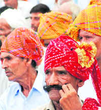 A man looks intently at the goings-on at the Rajput sammelan held in Karnal on Friday.