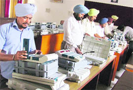Officials inspect EVMs at Bachat Bhawan in Ludhiana on Friday. 