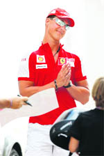 Former Formula One driver Michael Schumacher reacts to supporters asking for autographs during the first practice session at the European F1 Grand Prix in Valencia on Friday. 
