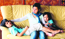 Muslim model Kartika Sari Dewi Shukarno, 32, who will be caned for drinking beer, sits with her children at her father's home in Karai, north of Kuala Lumpur, on Friday. Kartika will become the first woman in Malaysia to be flogged under Islamic law. 