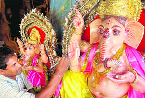 A sculptor gives final touches to idols of Lord Ganesh on the eve of Ganesh Chaturthi at Kali Bari Mandir in Chandigarh on Saturday.