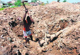 A labourer repairs a water supply pipe at the village on Saturday