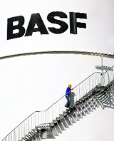 This file photo shows an employee of the German chemical giant BASF climbing up the stairs of an oil tank at the BASF plant in the eastern German town of Schwarzheide.