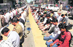 People offer mid-day prayers on the first day of Ramzan in Srinagar on Sunday. During this month, Muslims keep fast for the entire day and break it in the evening. The end of the holy month marks the Eid-ul-Fitr celebrations