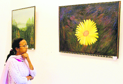 Bably S Singh looks at one of her paintings, signifying hope.