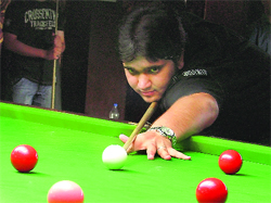 Aayush Kumar concentrates during the title clash match in the junior section of the Punjab Snooker Championship being held in Ludhiana on Sunday. 