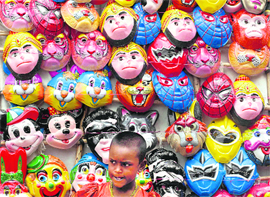A child stands in front of a stall of masks in Hyderabad on Sunday.