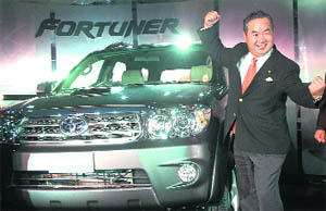 Toyota Motor Corps senior managing director Akira Okabe poses with SUV Fortuner at its launch in New Delhi on Monday. The SUV, equipped with 3.0 L D-4D diesel engine, is priced at Rs 18.45 lakh.