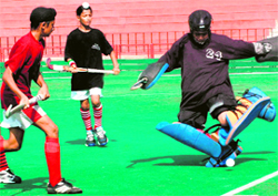 A player tries to turn away the ball during a match played between CHF Academy, Chandigarh, and MRS Academy, Amritsar, in the SN Vohra Memorial Sub-Junior (Under-14) Hockey Tournament held at Sector 42 Hockey Stadium in Chandigarh.