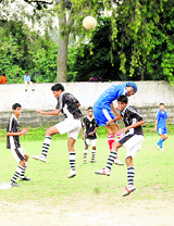 Players slug it out during a match at the District Football League in Dehradun on Monday.