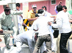 Members of two groups clash near the court premises in Rohtak on Monday.
