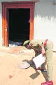 A police officer inspects the crime spot in the Chawadi area of Sainik Colony in Jammu