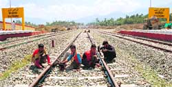 Workers giving the final touches to the Qazigund rail track scheduled to become functional soon