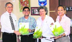 The PAU Vice-Chancellor, Dr MS Kang, presents university brochures to delegates from Alabama in Ludhiana