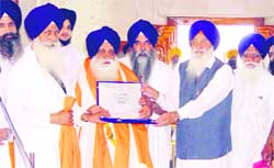 Giani Mohan Singh, sacked additional head granthi, being honoured by SGPC president Avtar Singh Makkar on his retirement in Amritsar