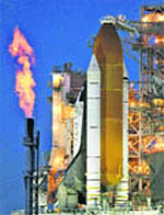 A furnace burns off extra fuel near the space shuttle Discovery at the Kennedy Space Center in Cape Canaveral on Monday.
