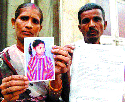 Sonu Parsad and his wife Sundari Devi show the picture of their daughter in Amritsar. 
