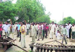 Villagers block the Kaithal-Panipat highway on Tuesday in protest against the death of a woman.