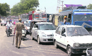 People caught in a traffic jam on the Jammu-Pathankot highway as various Sikh organisations held a protest against the Motor Vehicles Department in Jammu on Tuesday. 