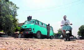 People face hardship due to potholes on the Jammu-Pathankot National Highway near Digiana Pully.