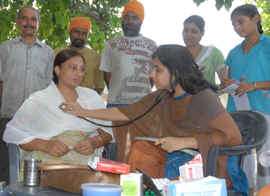 A woman goes through checkup during a camp at Kadian Wali village. 