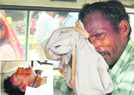 A friend of the labourer (inset) who died in a wall collapse in Ludhiana on Tuesday. 