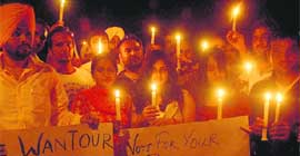 Students take part in a candlelight march for peace in Panjab University