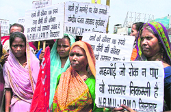 Activists of the Northern Railwaymen Union, along with other labour organisations, hold a protest against the rising prices of essential commodities, in Ludhiana on Wednesday