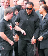 Boxing great Muhammad Ali and his wife Lonnie arrive for a visit to the gym of boxer Ricky Hatton (L), in Manchester on Wednesday.