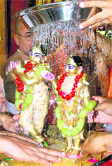 ISKCON devotees perform jal abhisheka ceremony of Radha Madhav at Hare Krishna Dham, Sector 36, in Chandigarh on Thursday. 