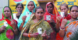 Women show their inked fingers after casting votes in the Samaypur Badli by-election in north Delhi on Thursday.