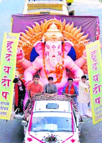 An idol of Lord Ganesh is taken out in a procession to celebrate Ganesh Utsav in Jammu