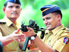 Cops take a look at weapons imported for the police department in Mumbai on Thursday.