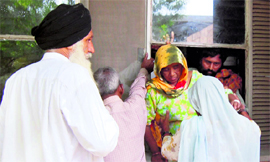 Patients and their relatives come out of Guru Nanak Dev Hospital through a window as agitating doctors shut down the OPD at the hospital in Amritsar on Thursday.