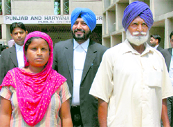 Charanjit Kaur, Jora Singh and their counsel at the Punjab and Haryana High Court on Thursday.