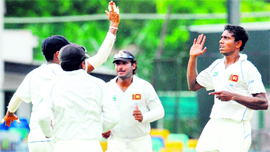 Sri Lankan cricketer Thilan Thushara (right) celebrates with teammates after the dismissal of New Zealand cricketer Daniel Flynn at The Sinhalease Sports Club (SSC) grounds in Colombo on Thursday.