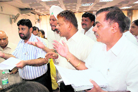 Councillors protest after the Mayor adjourned the MC House meeting in Chandigarh on Friday.