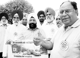 Eminent citizens sport badges after being appointed traffic marshals by the police in Mohali on Friday.