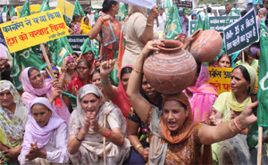 INLD activists stage a dharna against rising prices of essential commodities in Gurgaon on Friday. 