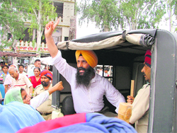 Randhir Singh, husband of Ward No. 1 councillor, Rattanjit Kaur Sebia, being taken by the police amid protest in Ludhiana on Friday. 