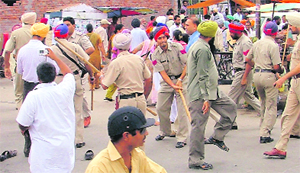The police resorts to a canecharge to disperse supporters of Ranjit Singh Sebia in Ludhiana on Friday. 