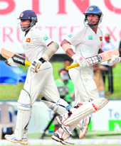 Kumar Sangakkara (R) and Mahela Jayawardene run between wickets on Friday. 